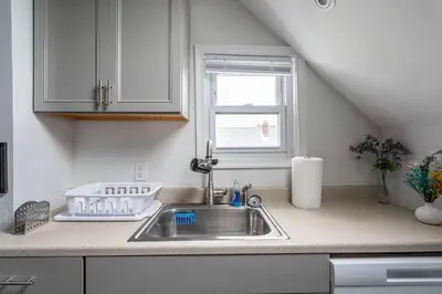 a kitchen counter with a sink and a window at Spacious 4BR 1BA Duplex Apartment Near NYC in Bayonne