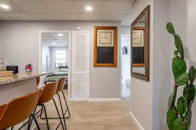 a hallway with chairs and a bar in a room at Updated 3BR 2BA Apartment Near NYC Airport in Bayonne