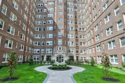 a large brick building with a courtyard in front of it at Fairfax Apartments 303 Spacious 1 Bed 1 Bth in Philadelphia