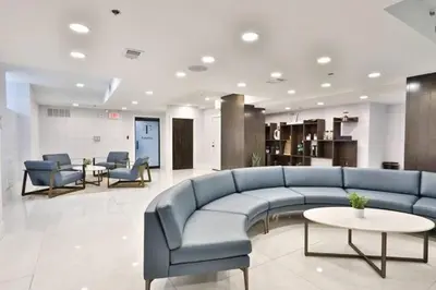 a lobby with a blue couch and chairs and tables at Fairfax Apartments 303 Spacious 1 Bed 1 Bth in Philadelphia