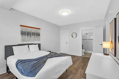 a white bedroom with a bed and a desk at Fairfax Apartments 425 Spacious 1 Bed 1 Bth in Philadelphia