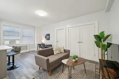 a living room with a couch and a table at Fairfax Apartments 425 Spacious 1 Bed 1 Bth in Philadelphia