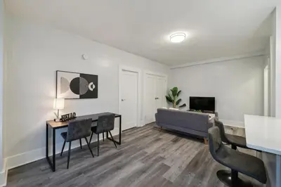 a living room with a table and a couch at Fairfax Apartments 425 Spacious 1 Bed 1 Bth in Philadelphia
