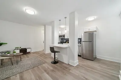 a kitchen and living room with a counter and a table at Fairfax Apartments 603 Spacious 1 Bed 1 Bth in Philadelphia