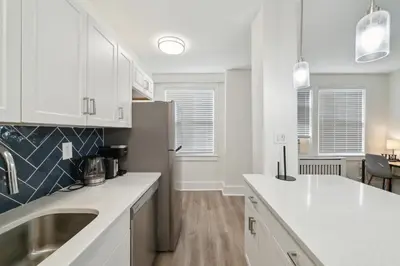 a white kitchen with a sink and a refrigerator at Fairfax Apartments 603 Spacious 1 Bed 1 Bth in Philadelphia