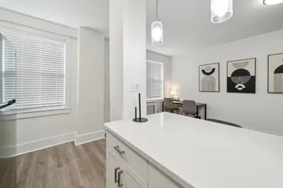a white kitchen with a white counter and a table at Fairfax Apartments 603 Spacious 1 Bed 1 Bth in Philadelphia