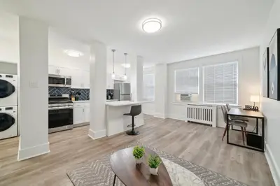 a large white kitchen with a table and a desk at Fairfax Apartments 603 Spacious 1 Bed 1 Bth in Philadelphia