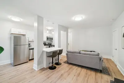 a living room with a couch and a kitchen at Fairfax Apartments 604 Spacious 1 Bed 1 Bth in Philadelphia