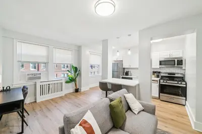 a living room with a couch and a table at Fairfax Apartments 604 Spacious 1 Bed 1 Bth in Philadelphia