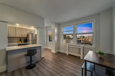 a kitchen with a counter top and two windows at Fairfax Apartments 725 Spacious 1 Bed 1 Bth in Philadelphia