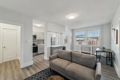 a living room with a couch and a kitchen at Fairfax Apartments 725 Spacious 1 Bed 1 Bth in Philadelphia