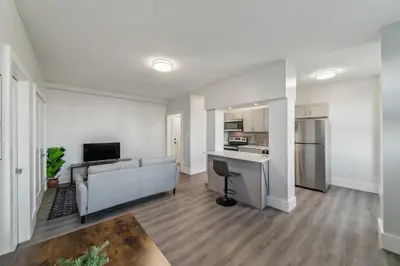a living room with a couch and a kitchen at Fairfax Apartments 725 Spacious 1 Bed 1 Bth in Philadelphia
