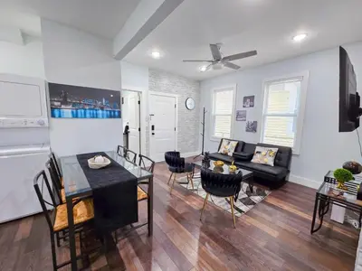 a living room with a couch and a table at Cozy apartment near New York City in Jersey City