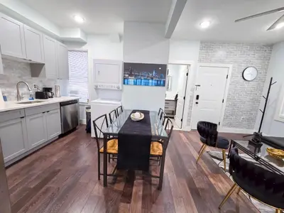 a kitchen and dining room with a table and chairs at Cozy apartment near New York City in Jersey City