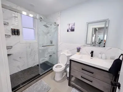 a bathroom with a shower and a toilet and a sink at Cozy apartment near New York City in Jersey City