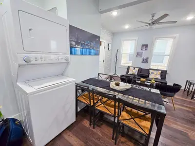 a kitchen and dining room with a table and a refrigerator at Cozy apartment near New York City in Jersey City