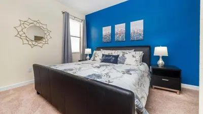 a bedroom with a large bed with blue walls at MYR1456 in Philadelphia