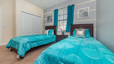 a bedroom with two beds and a window with blue curtains at MYR1456 in Philadelphia