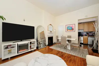 a living room with a large flat screen tv at Prime Murray Hill 1BR - Near Grand Central in New York
