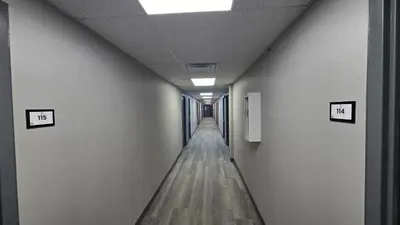 an empty corridor in an office building with a long hallway at Roosevelt Inn at Roosevelt Blvd, Philadelphia, PA in Philadelphia