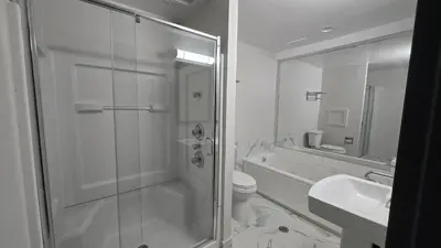 a bathroom with a shower and a toilet and a sink at Roosevelt Inn at Roosevelt Blvd, Philadelphia, PA in Philadelphia