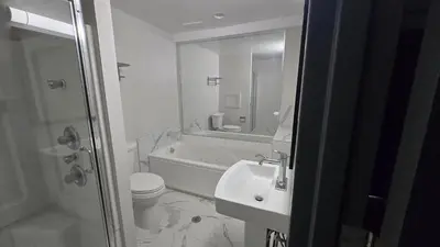 a bathroom with a tub and a sink and a toilet at Roosevelt Inn at Roosevelt Blvd, Philadelphia, PA in Philadelphia