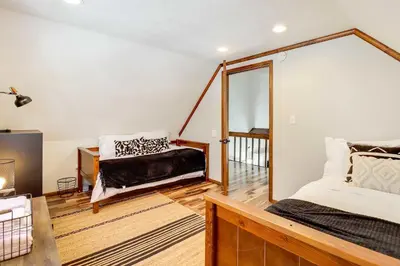 a bedroom with a bed and a balcony at Chalet retreat in Tobyhanna in Tobyhanna