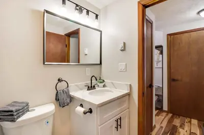 a bathroom with a sink and a mirror and a toilet at Chalet retreat in Tobyhanna in Tobyhanna