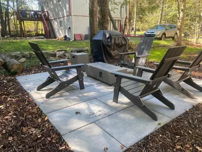 two chairs and a picnic table with a tent at Chalet retreat in Tobyhanna in Tobyhanna