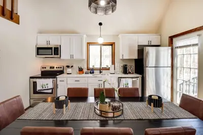 a kitchen with a table and a refrigerator at Chalet retreat in Tobyhanna in Tobyhanna