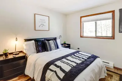 a bedroom with a large bed and a window at Chalet retreat in Tobyhanna in Tobyhanna
