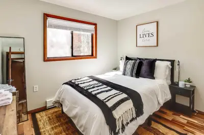 a bedroom with a bed with a black and white comforter at Chalet retreat in Tobyhanna in Tobyhanna