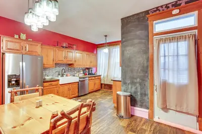a kitchen with a table and a refrigerator at Historic Home with Yard in the Heart of Reading! in Reading