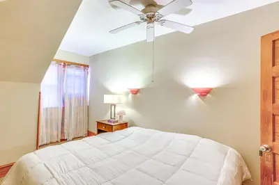 a bedroom with a white bed and a ceiling fan at Historic Home with Yard in the Heart of Reading! in Reading