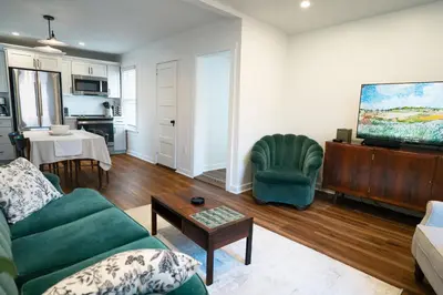a living room with a couch and a table at Stylish Apt Walk to Shops, Dining, and Bucknell in Lewisburg
