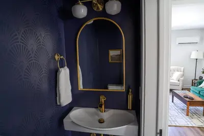 a bathroom with a sink and a mirror at Stylish Apt Walk to Shops, Dining, and Bucknell in Lewisburg