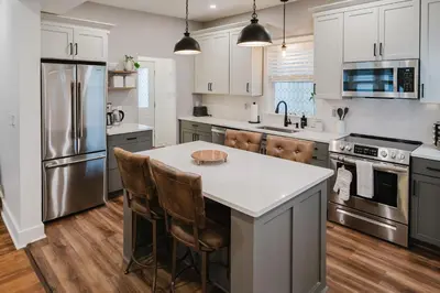 a kitchen with stainless steel appliances and a white counter top at Garden Retreat Steps from Downtown Lewisburg in Lewisburg