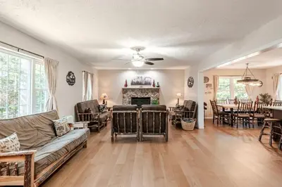 a living room with a couch and a fireplace at The Hangout Haven - Theater, Hot tub, Pickleball, Ping pong, Firepit in Long Pond