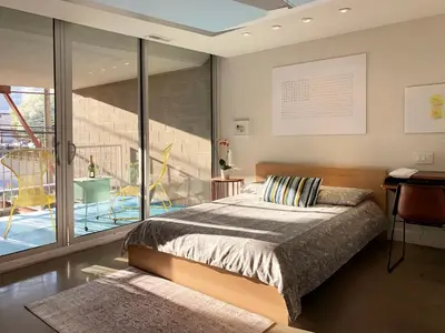 a bedroom with a large bed and a balcony at Loft Suite with private patio in Art Tower in Philadelphia
