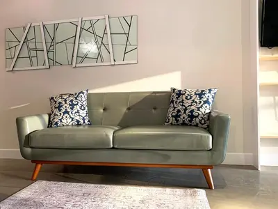 a green couch in a living room with pillows at Loft Suite with private patio in Art Tower in Philadelphia