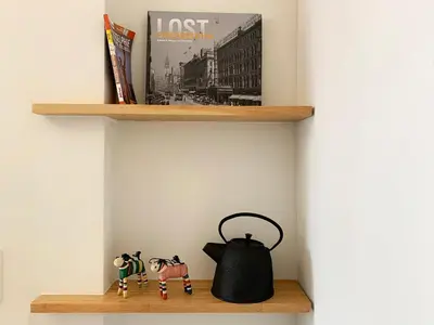 a shelf with a tea kettle and a book at Loft Suite with private patio in Art Tower in Philadelphia