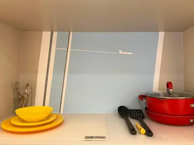 a kitchen counter with a red pot and yellow plates at Loft Suite with private patio in Art Tower in Philadelphia