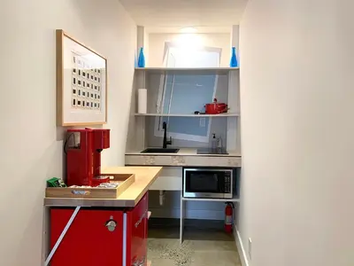 a small kitchen with a counter and a microwave at Loft Suite with private patio in Art Tower in Philadelphia