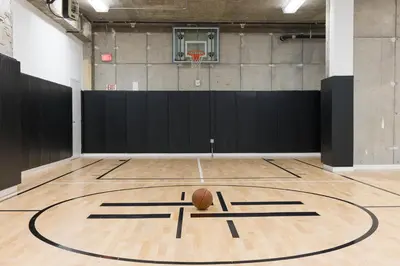 an empty gym with a basketball on the court at Chique Loft 10 Min from NYC with Gym, Pool & Sauna in Jersey City