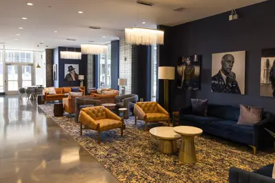 a living room with couches and chairs and tables at Chique Loft 10 Min from NYC with Gym, Pool & Sauna in Jersey City
