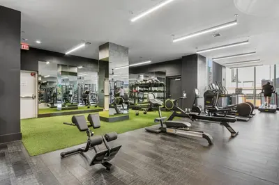 a gym with several treadmills and exercise bikes at Chique Loft 10 Min from NYC with Gym, Pool & Sauna in Jersey City