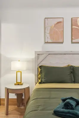 a bedroom with a bed and a table with a lamp at Stay at Luna on 800 Callowhill in Philadelphia