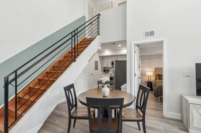 a dining room with a table and chairs and a staircase at Stay at Luna on 800 Callowhill in Philadelphia