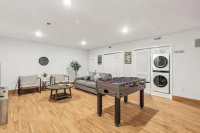 a living room with a couch and a ping pong table at Stay at Luna on 800 Callowhill in Philadelphia