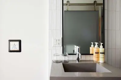 a bathroom with a sink and a mirror at Arlo SoHo in New York